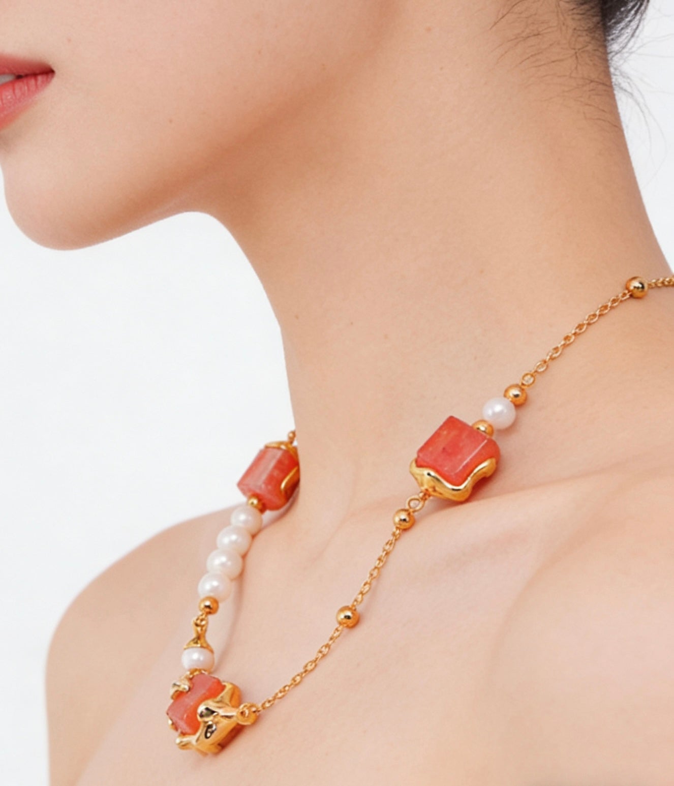 Close up of cubic crystal and freshwater pearl necklace on woman silver tone jewelry