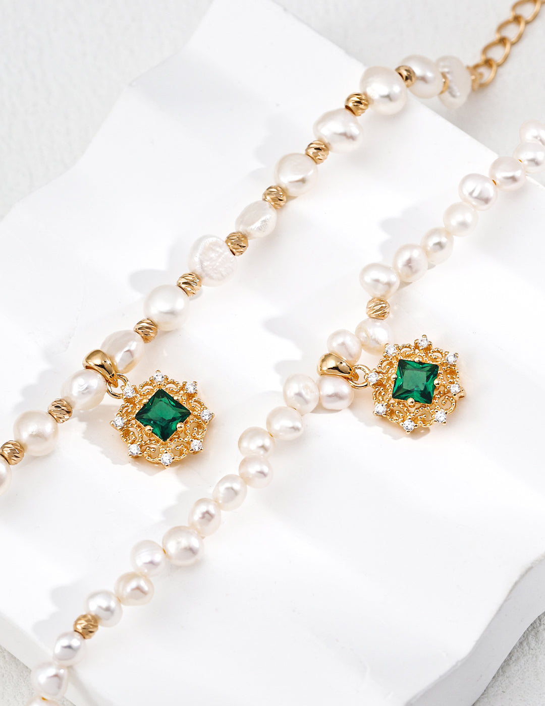 Flat lay of pearl and zircon bracelet styled with matching necklace, ideal for gifting and special occasions