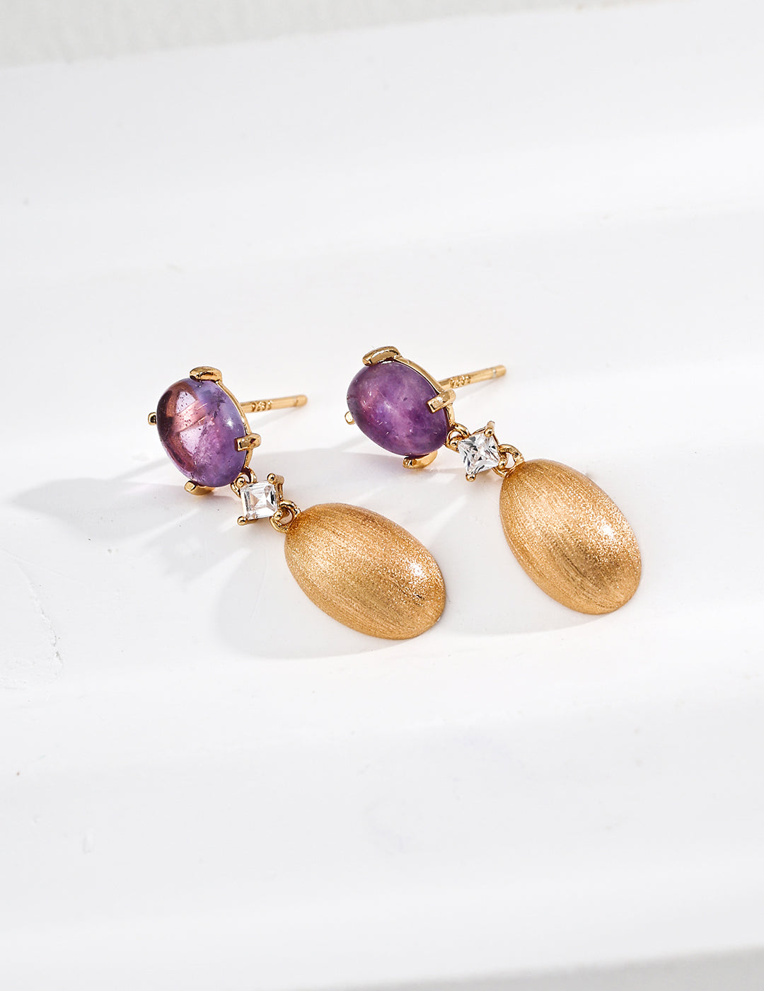 close up of oval amethyst and cz on 925 silver earrings